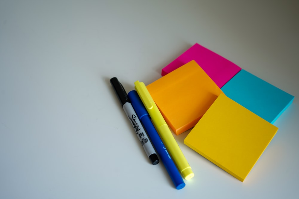 Blue and black pen beside orange sticky notes photo – Free Sticky